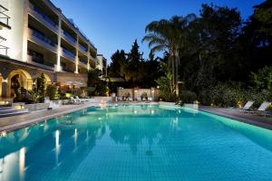 a large swimming pool in front of a building at Rodos Park in Rhodes Town