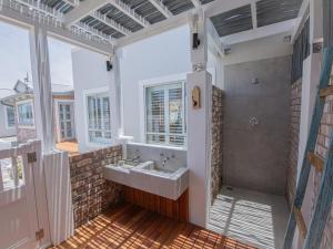 a bathroom with a sink and a shower at Good Karma in Swakopmund