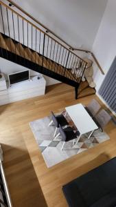 an overhead view of a living room with a chair and stairs at Spacious loft apartment with a lake view in Tampere