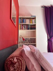 a bedroom with a bed and a book shelf with books at Draisina Bike ROOM in Oleggio Castello