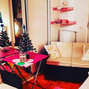 a living room with a christmas tree and a couch at Pink Panter Doboj in Doboj