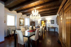 a dining room with a table and chairs and a chandelier at The Blue House in Tolmin