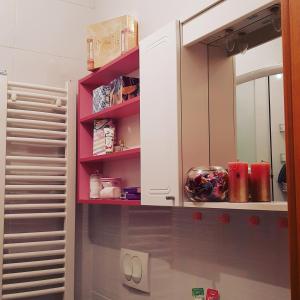 a kitchen with white cabinets and pink shelves at Pink Panter Doboj in Doboj