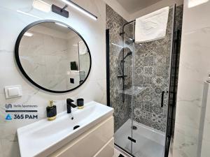 a bathroom with a sink and a shower at Apartament Różana Polana z Ogrodem - 365PAM in Sianozety