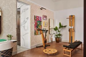 a living room with a treadmill and a mirror at Andaz Prague, By Hyatt in Prague +149 photos