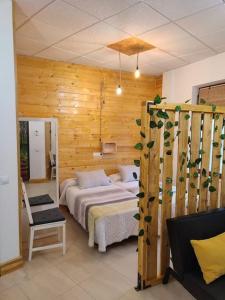 1 dormitorio con 1 cama y pared de madera en Estudio Mota, 