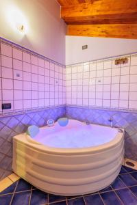 uma grande banheira numa casa de banho em azulejo em Green Park Bio Agriturismo em Trentinara