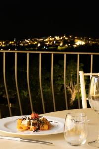 a plate of food on a table with wine glasses at Green Park Bio Agriturismo in Trentinara