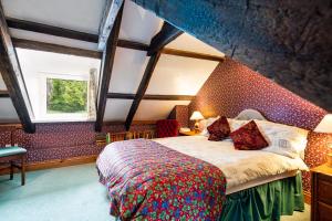 a bedroom with a large bed in an attic at Upper Cottage Newcastle Emlyn in Cwm-pengraig