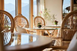 a group of tables and chairs with flowers on them at Mineralienhotel Natznerhof in Natz-Schabs