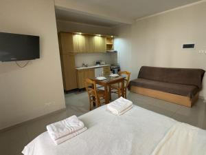 a bedroom with a bed and a couch and a table at The Triton in St Paul's Bay
