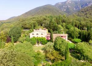 an aerial view of a house in the mountains at Can Serola in Sales del Llierca