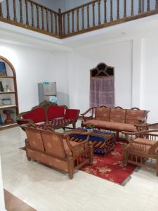 a living room with couches and chairs on a floor at Pearl Rest in Mannar
