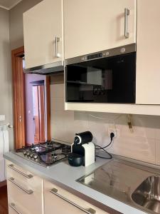 a kitchen with a stove and a toaster on a counter at Easy Milano - Rooms and Apartments Navigli in Milan