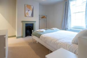a bedroom with a bed and a fireplace at Pass the Keys Stylish Grade II listed house in Cheltenham