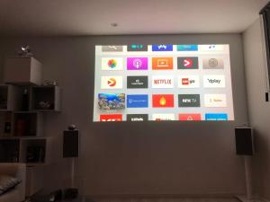 a projection screen on a wall with different apps at Panorama view! Modern,Balcony/parking in Bodø