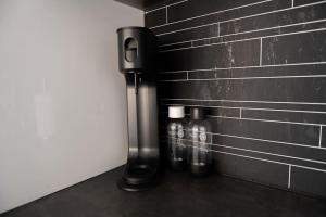 two bottles of water are next to a brick wall at Panorama view! Modern,Balcony/parking in Bodø