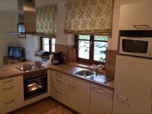 a kitchen with a sink and a microwave at Appartement Dertnig in Wagrain