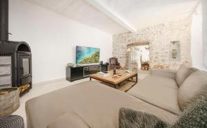 a living room with a couch and a fireplace at The Stone House in Zaton
