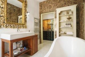 a bathroom with a large mirror and a tub at The Stone House in Zaton +181 photos