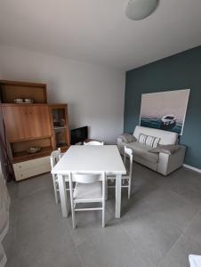 a living room with a white table and a couch at Casa Marica - Appartamento nel Borgo di Pieve in Tremosine Sul Garda
