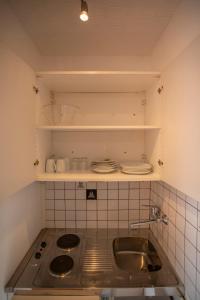 a kitchen with a sink and a counter top at Airport Studio Innsbruck I Free Parking in Innsbruck