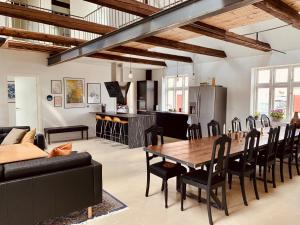 a kitchen and living room with a table and chairs at Fantastic farm holiday in Ebeltoft