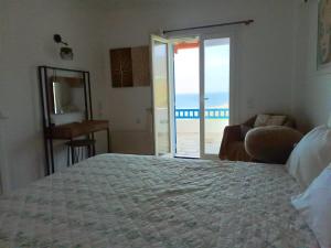 a bedroom with a bed with a view of the ocean at Villa Victoria with Sea View and Two Private Pools in Elia