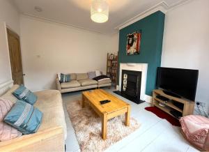 a living room with a couch and a coffee table at Charming cottage retreat with garden - sleeps 12 in Bristol