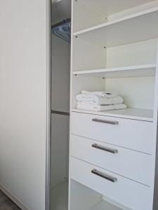 a white refrigerator with white towels in it at Sweet Home in Junín
