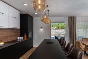 a kitchen and dining room with a table and chairs at Villa Visum Mare Unus in Mošćenička Draga