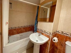 a bathroom with a sink and a toilet and a tub at Apartamentos Vistamar Marina D'Or 1º línea 3000 in El Borseral