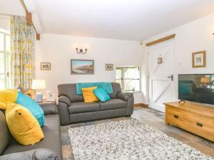 a living room with a couch and a flat screen tv at Braeburn - Uk38098 in Pilton