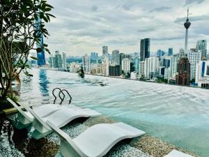 a infinity pool on the roof of a city at Axon Suites Kualalumpur in Kuala Lumpur