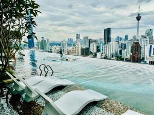 a infinity pool on the roof of a city at Axon Suites Kualalumpur in Kuala Lumpur