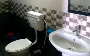 a bathroom with a toilet and a sink at Vedanta Homestay by StayApart in Mangpu