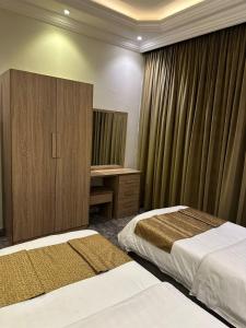 Кровать или кровати в номере Ghima Jeddah