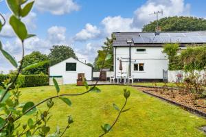 a white house with a lawn in front of it at Lower Cottage Newcastle Emlyn in Cwm-pengraig