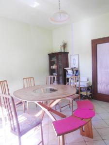 a dining room with a wooden table and chairs at Gästezimmer Casa Lundo 52 in Comano