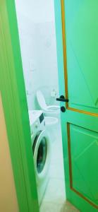 a bathroom with a washing machine and a toilet at Casa Fiore Olbia in Olbia