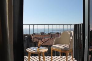 a balcony with two chairs and a table and a view at Four-G Hotel in Istanbul