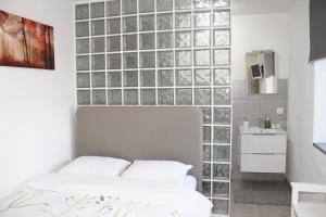 a bedroom with a wall of glass blocks at REST AND RESTAURANT in Roveredo in Roveredo