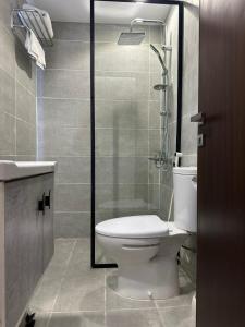 a bathroom with a toilet and a shower at Ghima Jeddah in Jeddah