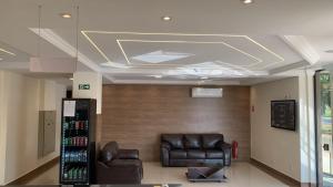 a waiting room with two leather chairs and a ceiling at Lazzarus Hotel - Standard Plus 02 Camas-Casal&Solt ou Solt&Solt in Alexânia