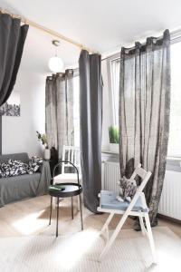 a living room with a dog sitting in a chair at - Cozy apartment in the heart of Duisburg with New York Design & Betten & Sofa - 5 Mins Central Station Hbf - Big TV & WiFi -· in Duisburg