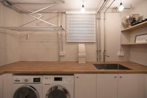 a kitchen with a washing machine and a sink at - Cozy apartment in the heart of Duisburg with New York Design & Betten & Sofa - 5 Mins Central Station Hbf - Big TV & WiFi -· in Duisburg