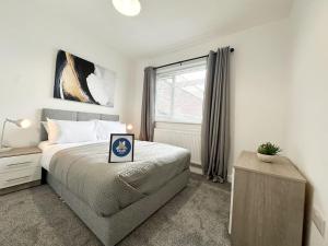 a bedroom with a bed and a window at High Market Place by Blue Skies Stays in Ashington