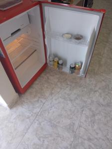 an empty refrigerator with its door open in a kitchen at departamento equipado Pioneros in Zapala