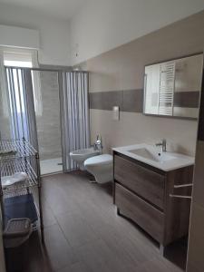 a bathroom with a sink and a tub and a toilet at Giardino Massari in Lecce +11 photos
