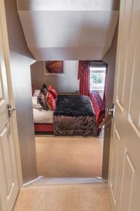 a small room with a bed with a cat sitting on it at Bay View - Private parking, beach views, central location in Kent